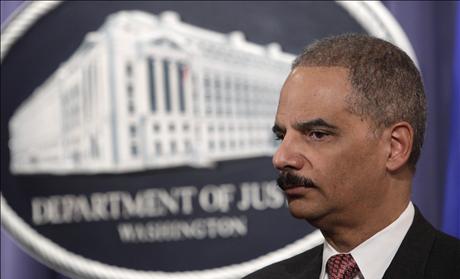 U.S. Attorney General Eric Holder pauses at a news conference at the Justice Department in Washington