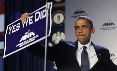 U.S. President Barack Obama holds up a sign at the American Nurses Association house of delegates meeting in Washington