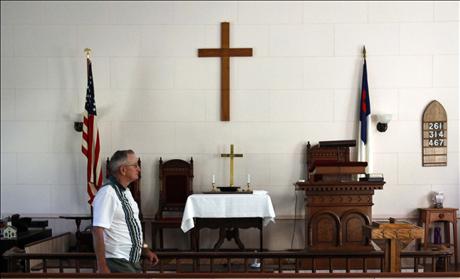 Howard Grace walks through the West Unity Community United Methodist Church before joining the weekly Bible study group in Unity