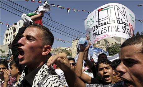 Palestinians take part in a rally in Hebron