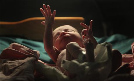 A baby gestures minutes after he was born inside the pediatric unit at hospital Escuela in Tegucigalpa