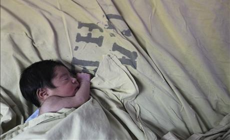 A baby is seen inside the childbirth unit at hospital Escuela in Tegucigalpa