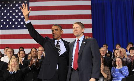 U.S. President Obama waves with Cordray during a trip Cleveland 