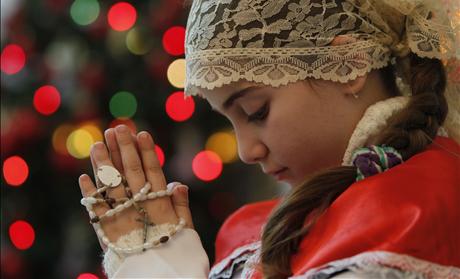 An Iraqi Christian girl attends a Christmas mass at Chaldean Catholic church in Amman