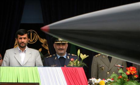 Iranian President Ahmadinejad watches as missile passes by during Army Day military parade in Tehran