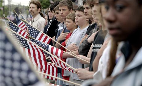 Local residents line the street as the funeral procession for Marine Lance Cpl. Walter O'Haire passes in Rockland