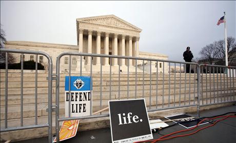 Signs are left behind after a pro-life demonstration at the Supreme Court in Washington