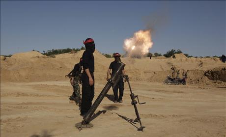 Palestinian militant of the DFLP fires a mortar during a training exercise in Rafah