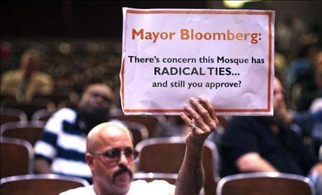 A demonstrator holds a sign during a Landmarks Commission's hearing on the proposed Cordoba Mosque to be built near the site of the former World Trade Center in New York
