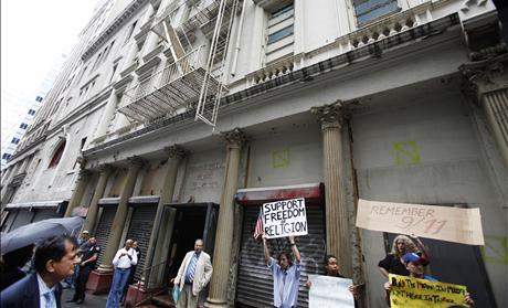 Demonstrators who support and oppose a proposed Muslim cultural center and mosque Park51 stand with signs in front of the site in New York