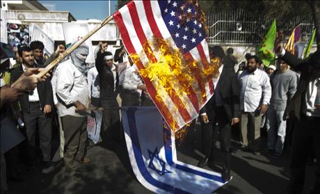 Iranian students burn a U.S. flag during a rally in support of the Bahraini nation in front of Bahrain's embassy in Tehran