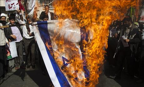 Iranian students burn an Israeli flag during a rally in support of the Bahraini nation in front of Bahrain's embassy in Tehran