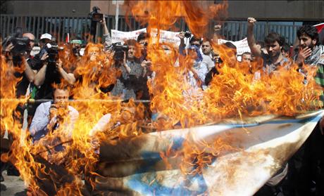 Demonstrators burn an Israeli flag during a protest in support of Palestinians, in front of the Israeli consulate in Istanbul