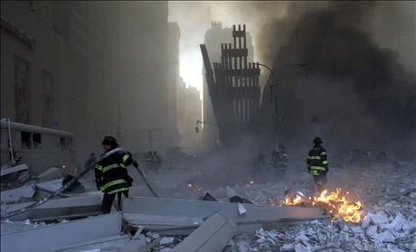 RESCUE CREWS LOOK AT WORLD TRADE CENTER DAMAGE.