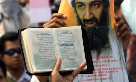 A COPY OF THE KORAN IS HELD UP DURING A AN ANTI-US RALLY IN JAKARTA.