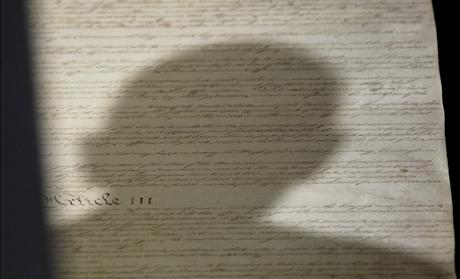 Shadow of head of U.S. President Obama falls upon copy of U.S. Constitution at National Archives in Washington