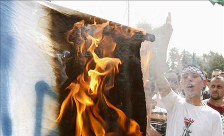 Jordanian supporters of opposition parties burn an Israeli flag and shout anti-Israel slogans during a demonstration in Amman
09/10/2009