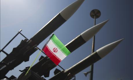 An Iranian flag is pictured next to missiles during a war exhibition to mark the anniversary of the Iran-Iraq war at Baharestan square near the Iranian Parliament in southern Tehran