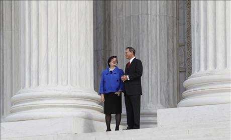 U.S. Supreme Court Justice Elena Kagan stands outside of the Supreme Court building with Chief Justice of the United States John Roberts after her investiture ceremony in Washington