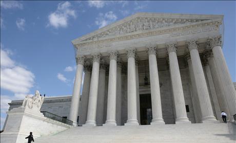 Security guards walk the steps of the Supreme Court before Justice Elena Kagan's investiture ceremony in Washington