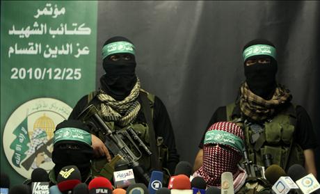 Members of Al-Qassam brigades, the armed wing of the Hamas movement, take part in a news conference in Gaza City