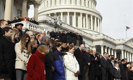 Members of Congress and other Capitol Hill staffers observe a moment of silence on the steps of the U.S. Capitol for Arizona Congresswoman Gabrielle Giffords in Washington