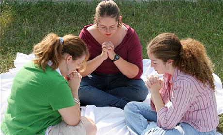 A group of teen girls gathered for prayer.
