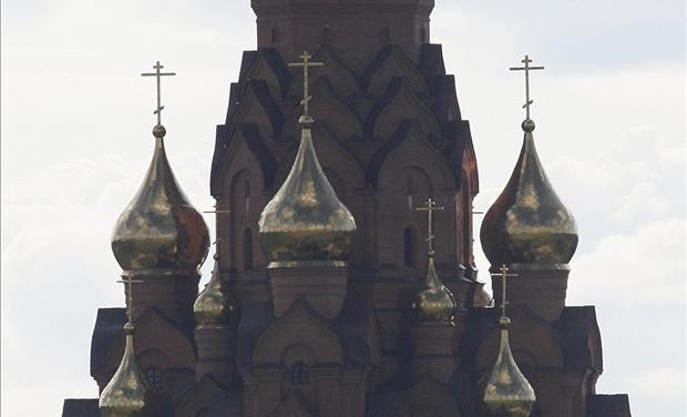 A tourist tent stands in front of an Russian Orthodox church in Lesosibirsk town 