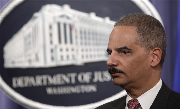 U.S. Attorney General Eric Holder pauses at a news conference at the Justice Department in Washington