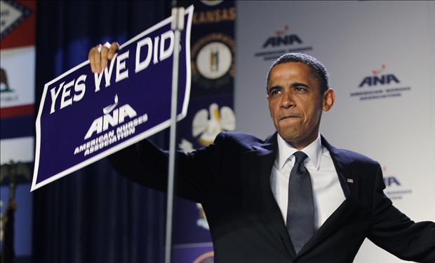 U.S. President Barack Obama holds up a sign at the American Nurses Association house of delegates meeting in Washington