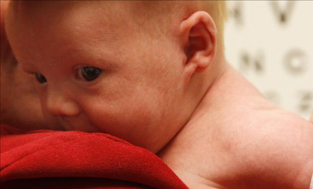 Michael Grabinski, two weeks old, has his arm measured at The Children's Hospital in Aurora
