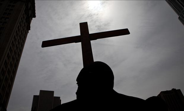 Frank Simmonds, of the Bay Ridge neighborhood of Brooklyn, holds a cross in City Hall Park in New York City