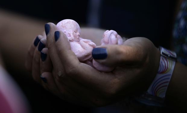 A prolife activist holds clay dolls in the shape of fetuses during a protest in Mexico City September 28, 2011. Mexico's Supreme court upheld a law within the Baja California state constitution that says that life begins at conception, signaling a victory for anti-abortion campaigners. Seven out of eleven ministers deemed the measure unconstitutional but eight votes were needed to overturn it.