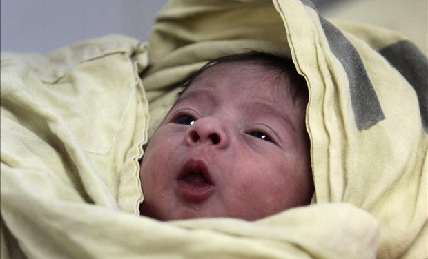 A baby is seen inside the childbirth unit at hospital Escuela in Tegucigalpa