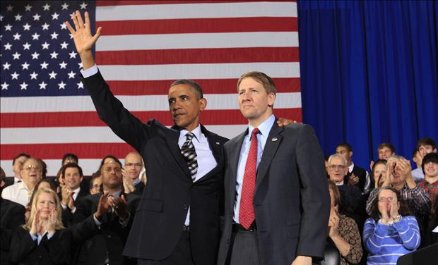 U.S. President Obama waves with Cordray during a trip Cleveland 
