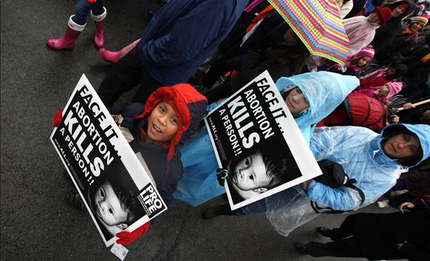 Children hold pro-life signs