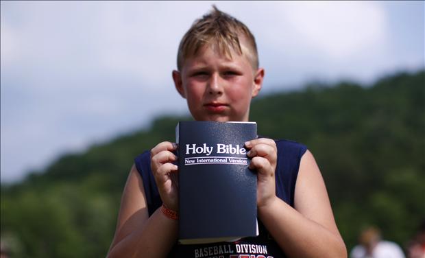 Boy with new bible after baptism during Creation08 Christian music festival in Mount Union Pennsylvania 