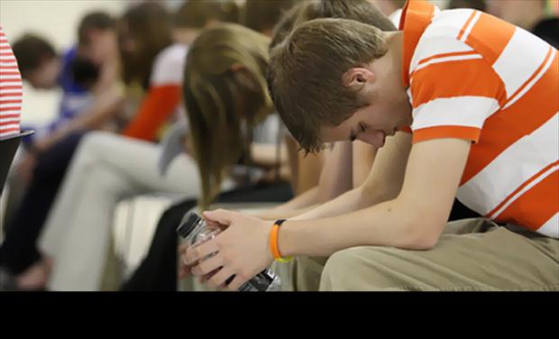 Josiah Vandy Bogurt prays during a National Day of Prayer service at International Aid in Spring Lake Township on Thursday, May 7, 2009.