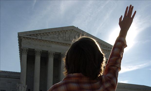 Anti-abortion advocate stands in prayer in front of Supreme Court in Washington DC