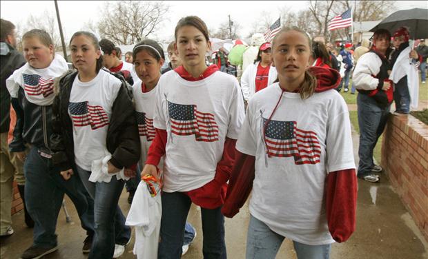 Students wearing t-shirts with U.S. flag arrive at school in Westminster