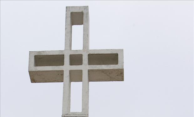 Men walk past Mount Soledad Cross which will be transferred to be owned by federal government