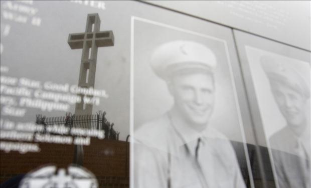 Mount Soledad Cross is seen in reflection on war memorial