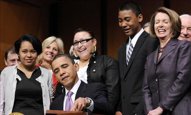 House Speaker Pelosi reacts as U.S. President Obama signs the Health Care and Education Reconciliation Act into law at Northern Virginia Community College in Alexandria
