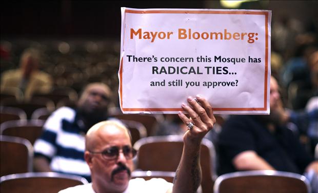 A demonstrator holds a sign during a Landmarks Commission's hearing on the proposed Cordoba Mosque to be built near the site of the former World Trade Center in New York