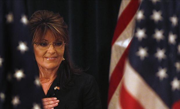Former Alaska governor Sarah Palin looks down during the Pledge of Allegiance before speaking to the LIA Annual Meeting & Luncheon at the Crest Hollow Country Club in Woodbury
