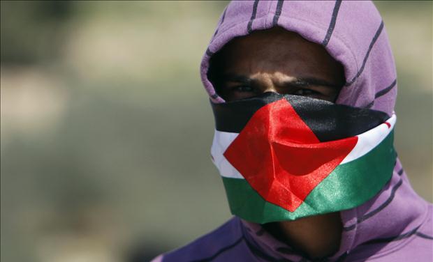 A Palestinian protester is seen during clashes at a protest in Bilin near Ramallah