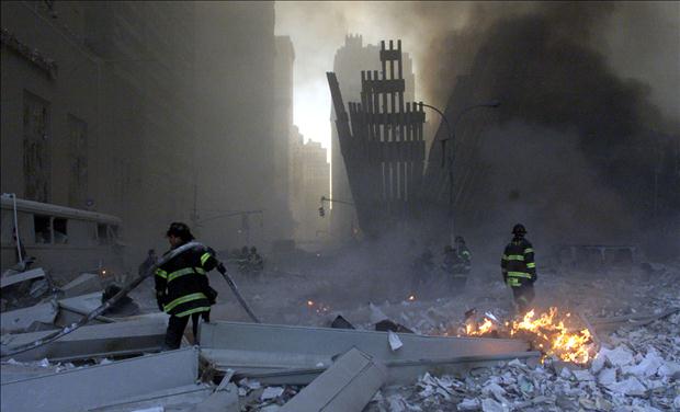 RESCUE CREWS LOOK AT WORLD TRADE CENTER DAMAGE.