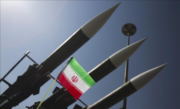An Iranian flag is pictured next to missiles during a war exhibition to mark the anniversary of the Iran-Iraq war at Baharestan square near the Iranian Parliament in southern Tehran