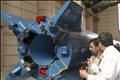 Iran's President Ahmadinejad looks at the Safir (ambassador) satellite-carrier rocket before launch at Iran's space centre in Tehran, Iran