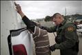 Border patrol agent catches illegal immigrant crossing into US.